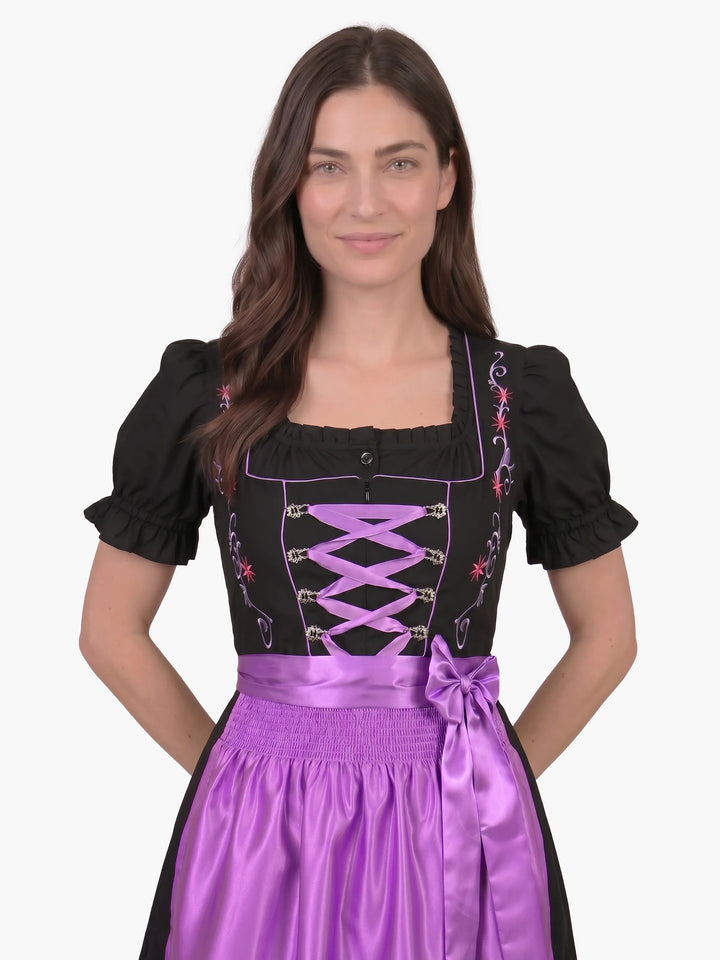 Enchanted Black Oktoberfest Dress Lilac Bloom with lilac satin apron and elegant floral embroidered bodice.